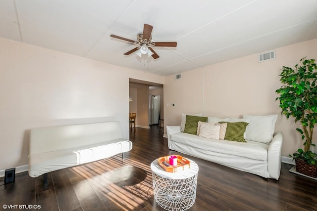 living room featuring ceiling fan and dark hardwood / wood-style floors