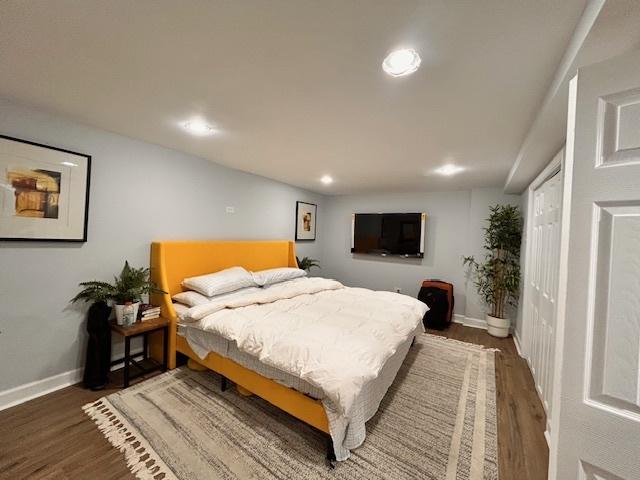 bedroom with dark hardwood / wood-style floors