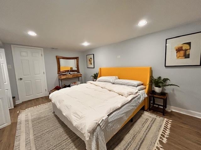 bedroom with dark hardwood / wood-style flooring