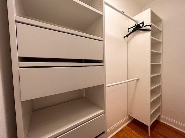 walk in closet featuring dark hardwood / wood-style flooring