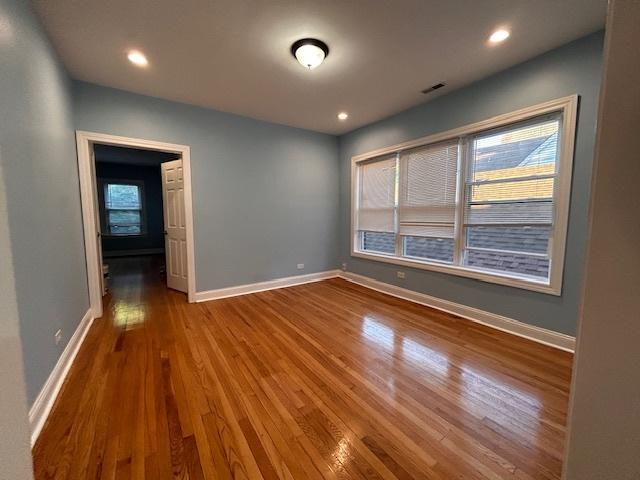 unfurnished room with wood-type flooring