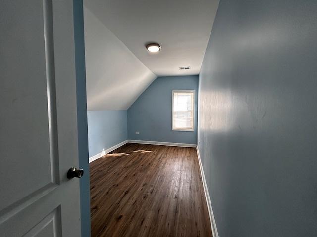 bonus room featuring dark hardwood / wood-style flooring and lofted ceiling