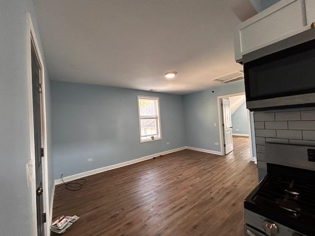 unfurnished living room featuring dark wood-type flooring