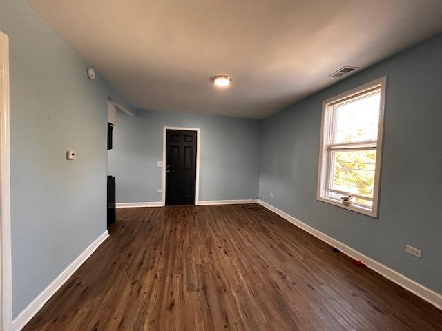 unfurnished room featuring dark wood-type flooring