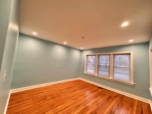 unfurnished room with wood-type flooring