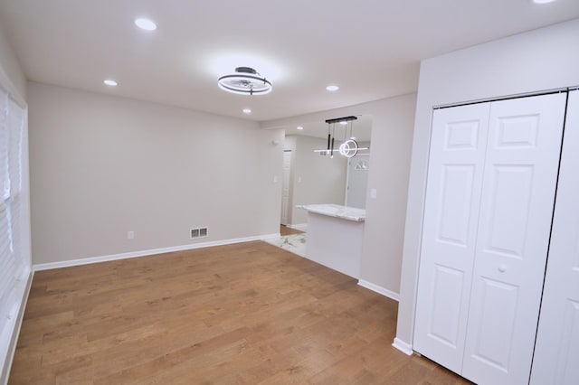 unfurnished room with wood-type flooring