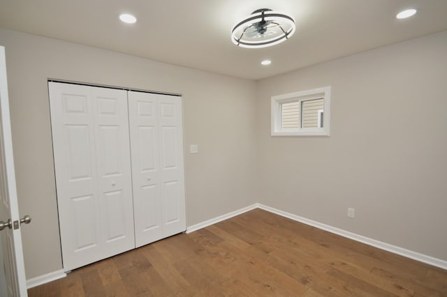 unfurnished bedroom with a closet and wood-type flooring