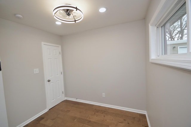 unfurnished room with dark wood-type flooring