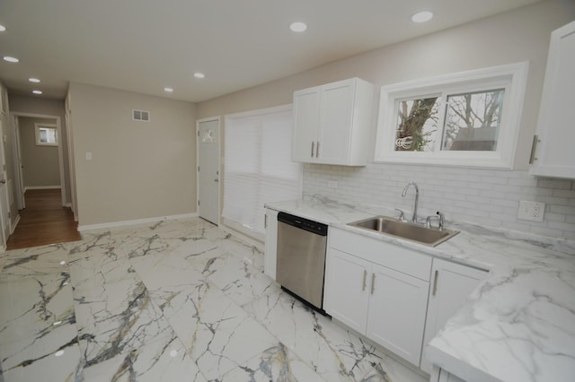 kitchen featuring stainless steel dishwasher, sink, and white cabinetry