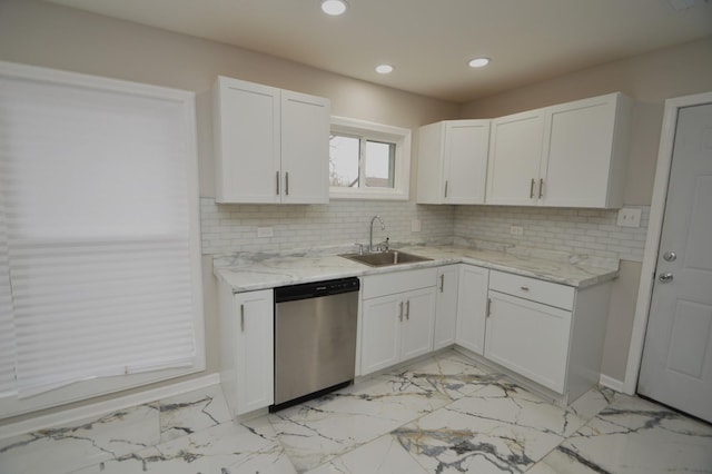 kitchen featuring sink, stainless steel dishwasher, tasteful backsplash, light stone counters, and white cabinets