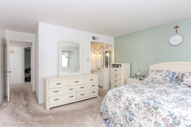 bedroom featuring light colored carpet and sink