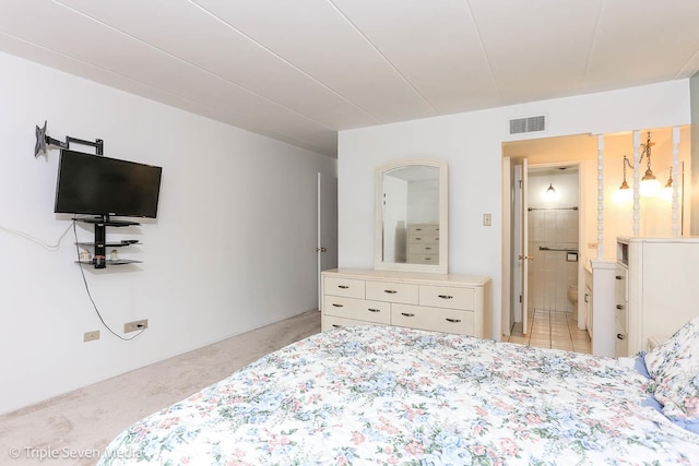 carpeted bedroom with ensuite bathroom