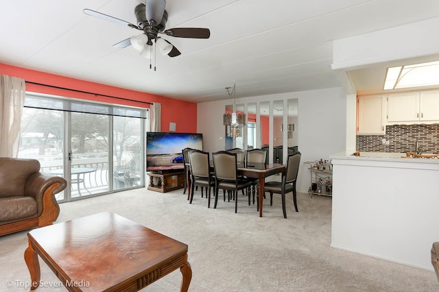 carpeted dining area featuring ceiling fan