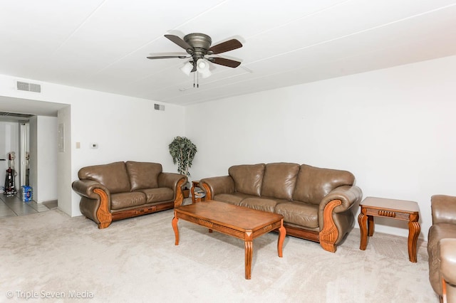 carpeted living room with ceiling fan