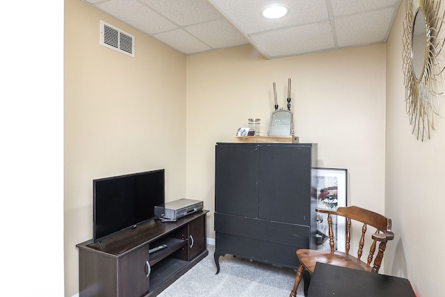 sitting room with carpet floors and a drop ceiling