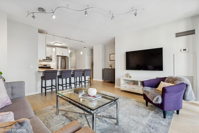 living room with light hardwood / wood-style flooring