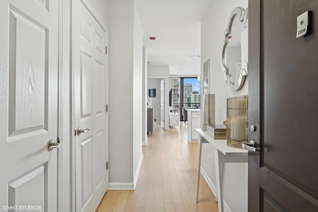 corridor with light hardwood / wood-style floors