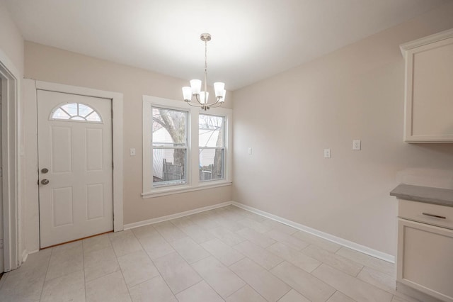 foyer entrance featuring an inviting chandelier