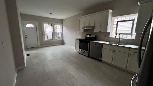 kitchen featuring sink, a wealth of natural light, stainless steel appliances, and white cabinets