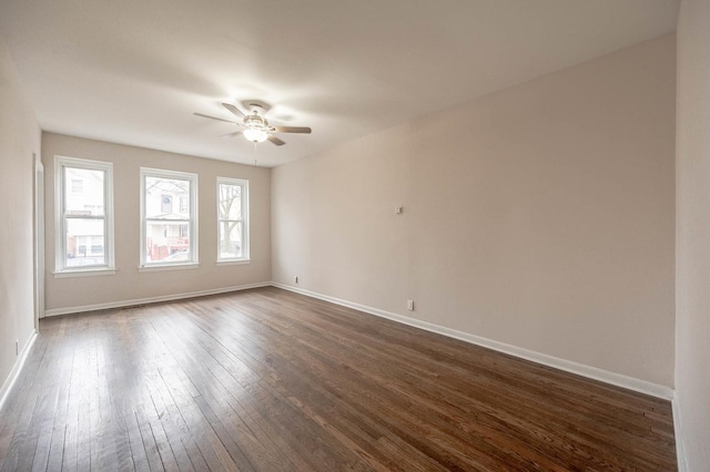 unfurnished room featuring dark wood-type flooring and ceiling fan