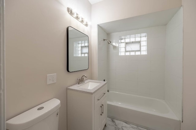 full bathroom with vanity, tiled shower / bath, and toilet