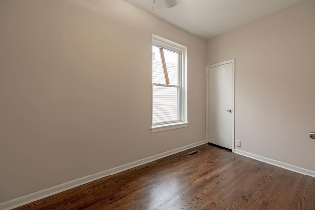 spare room featuring ceiling fan and dark hardwood / wood-style flooring