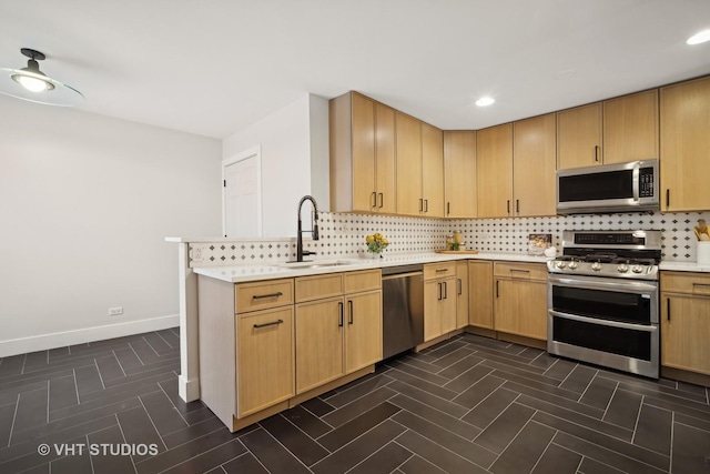 kitchen with light brown cabinets, stainless steel appliances, and sink