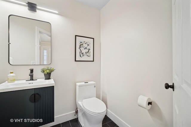 bathroom featuring toilet, vanity, and tile patterned floors