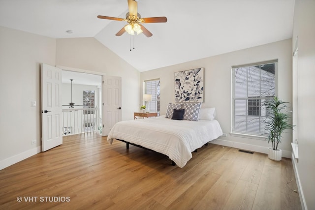 bedroom featuring ceiling fan, hardwood / wood-style floors, and lofted ceiling