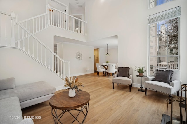 living room featuring hardwood / wood-style floors and a high ceiling