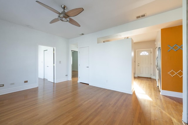 spare room with ceiling fan and light wood-type flooring