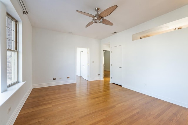 empty room with light hardwood / wood-style flooring and ceiling fan