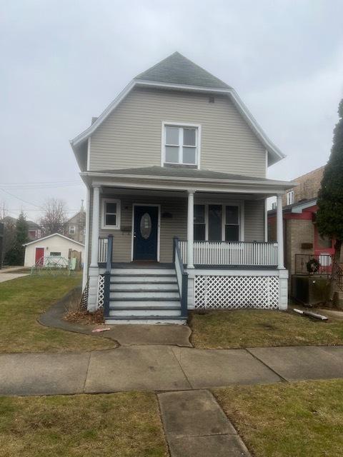 view of front of house featuring covered porch and a front lawn