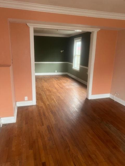 unfurnished room featuring wood-type flooring and crown molding