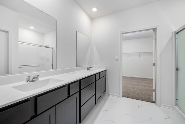 bathroom featuring vanity and an enclosed shower