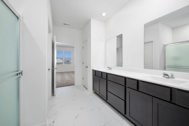 bathroom featuring vanity and a shower with door