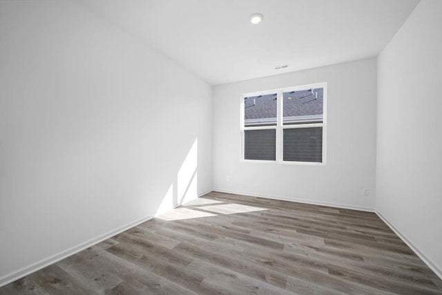 spare room with hardwood / wood-style floors