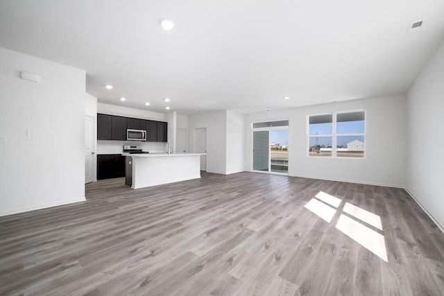 unfurnished living room with light hardwood / wood-style flooring