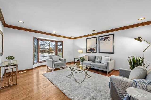 living room with light hardwood / wood-style floors and ornamental molding