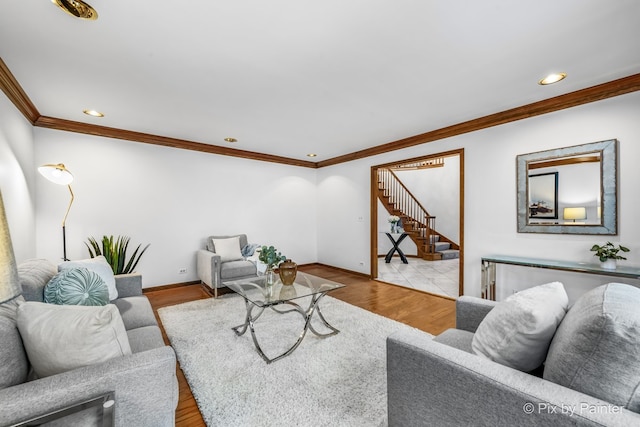 living room with ornamental molding and light wood-type flooring