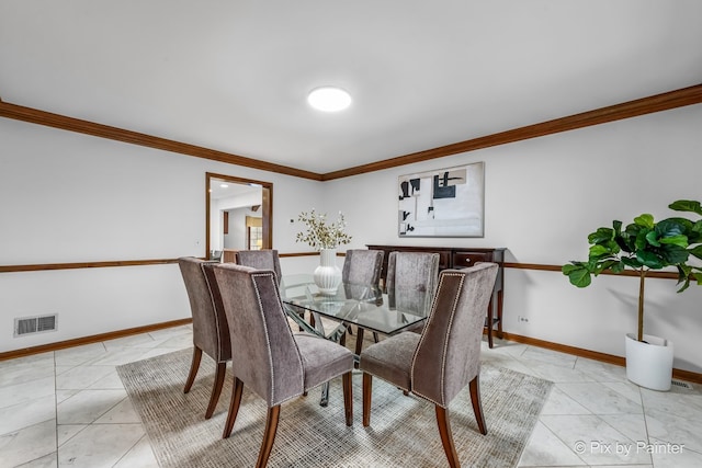 tiled dining area featuring ornamental molding