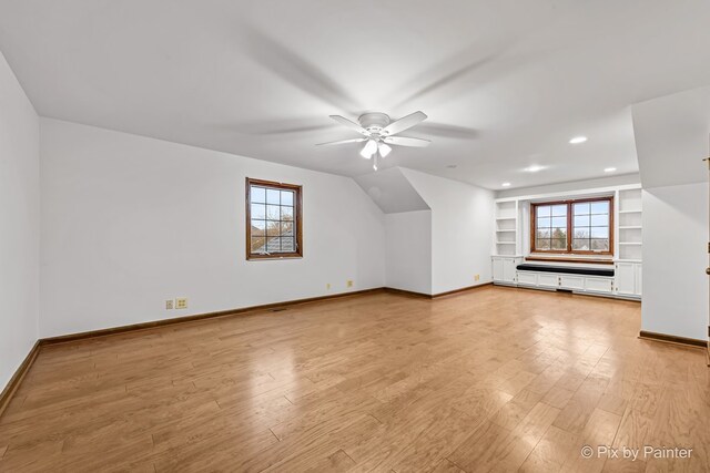 bonus room with ceiling fan, plenty of natural light, and light hardwood / wood-style flooring