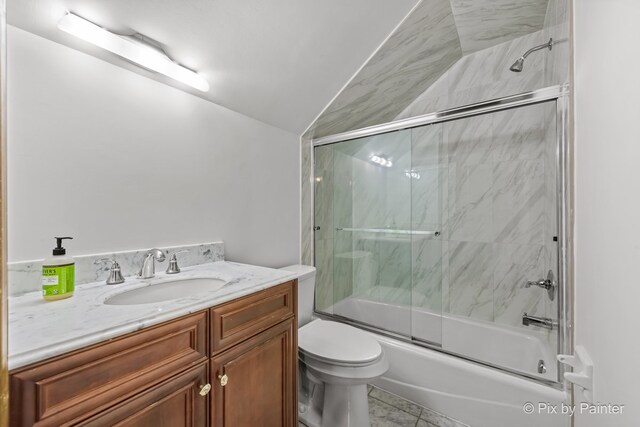 full bathroom with vanity, lofted ceiling, tile patterned flooring, toilet, and enclosed tub / shower combo