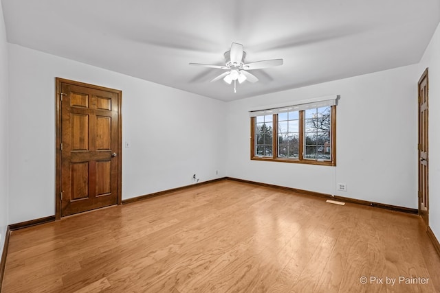 empty room with light hardwood / wood-style flooring and ceiling fan