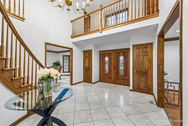 foyer entrance with a towering ceiling and an inviting chandelier