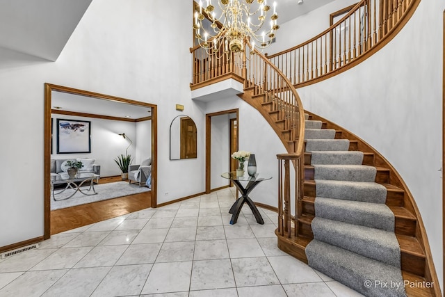 foyer with a chandelier and a high ceiling