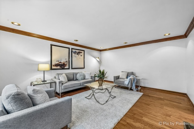 living room with hardwood / wood-style floors and ornamental molding