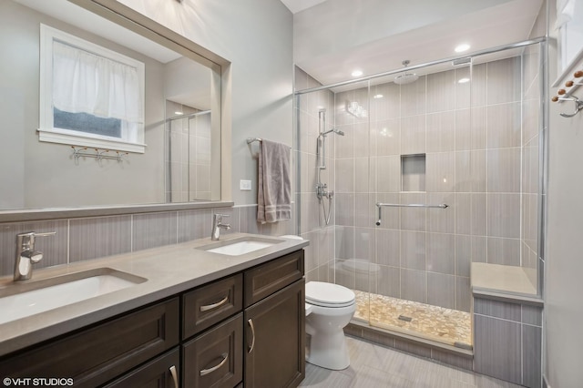 bathroom with vanity, toilet, and walk in shower