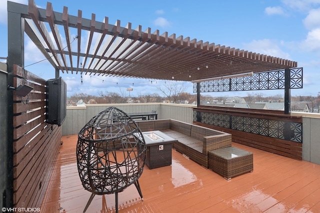 wooden deck featuring a pergola and an outdoor fire pit