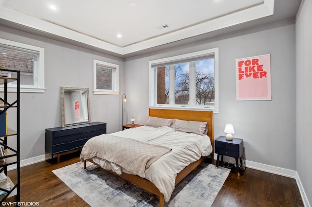 bedroom featuring a tray ceiling and dark hardwood / wood-style floors